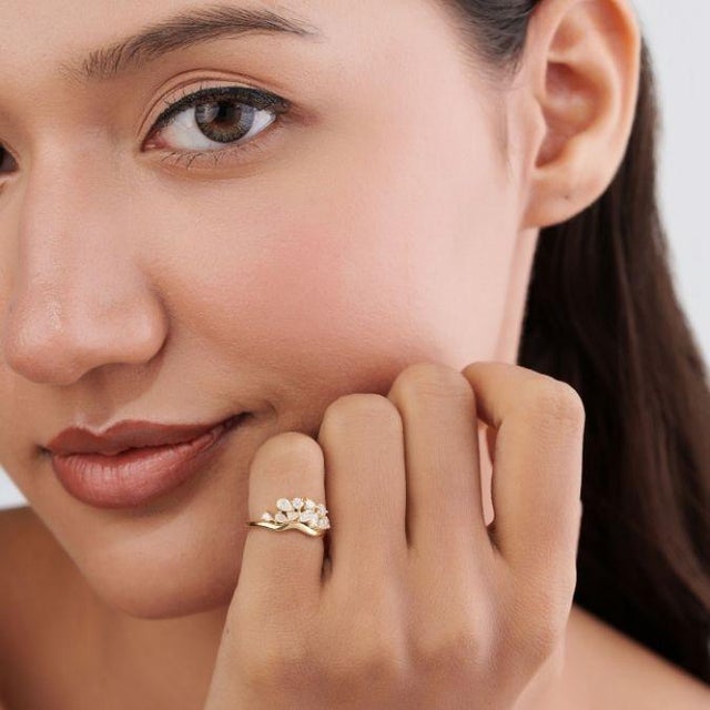 This cluster ring features 0.54 carats of certified natural mixed-cut diamonds, set in 14K yellow gold. in a graceful...