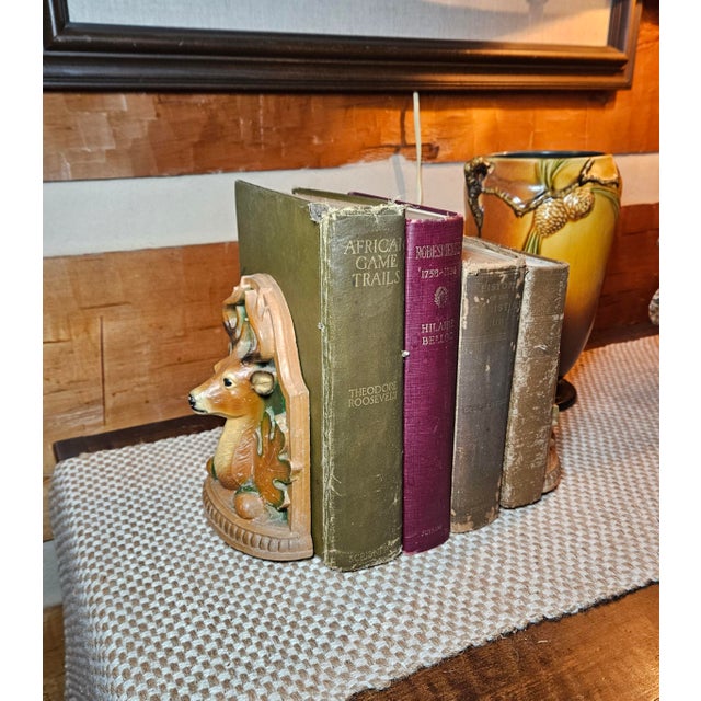 A beautiful pair of vintage deer head bookends, crafted from molded resin or composite and hand-painted with a faux wood...