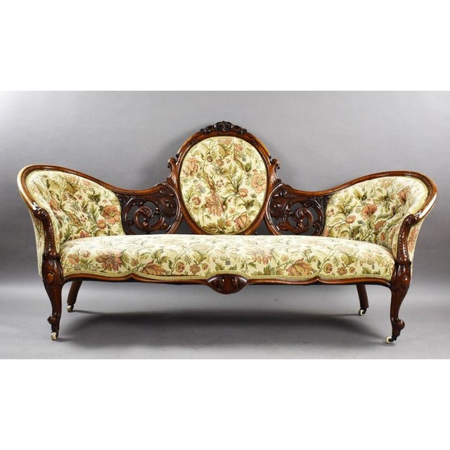 An elegant and decorative Victorian carved walnut chaise longue, dating to approximately circa 1860–1880. The chaise...