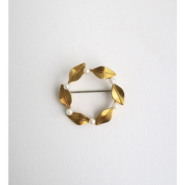 A beautiful, cultured pearl and gold-plated brooch pin with leaf design, circa 1950s, by Krementz, circa mid-20th century,...