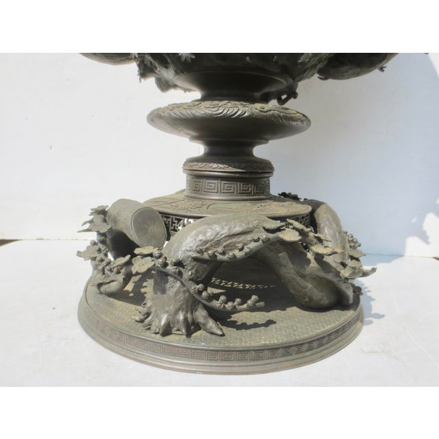 Meiji bronze basket with a design of eagles, snakes, frogs, and snails on the body, with a base of bent pine branches and...