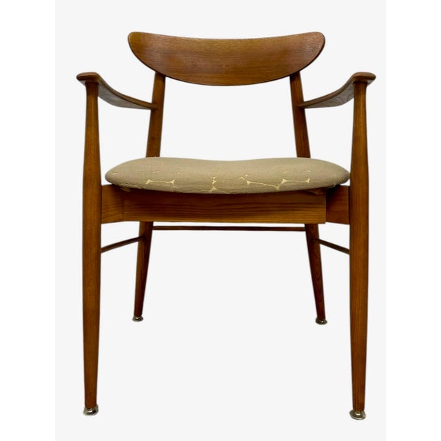 This vintage mid-century modern armchair features a sculptural wooden frame with clean, organic lines characteristic of...