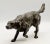 An early 20th-Century, French figurative bronze sporting dog sculpture of a hunting dog on point. The figural dog is...