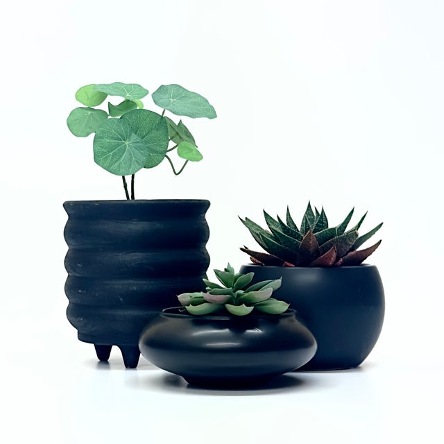 Black ceramic planters, group of 3. Set of matte black art deco planters in a variety of shapes and sizes. Shortest:...