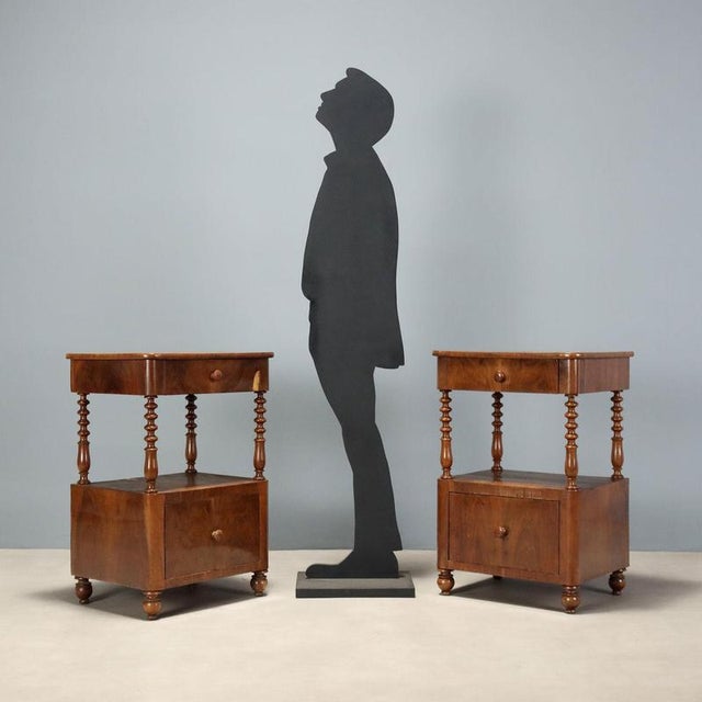 Pair of Louis Philippe walnut nightstands, crafted in Italy in the second quarter of the 19th century, exemplifying the...