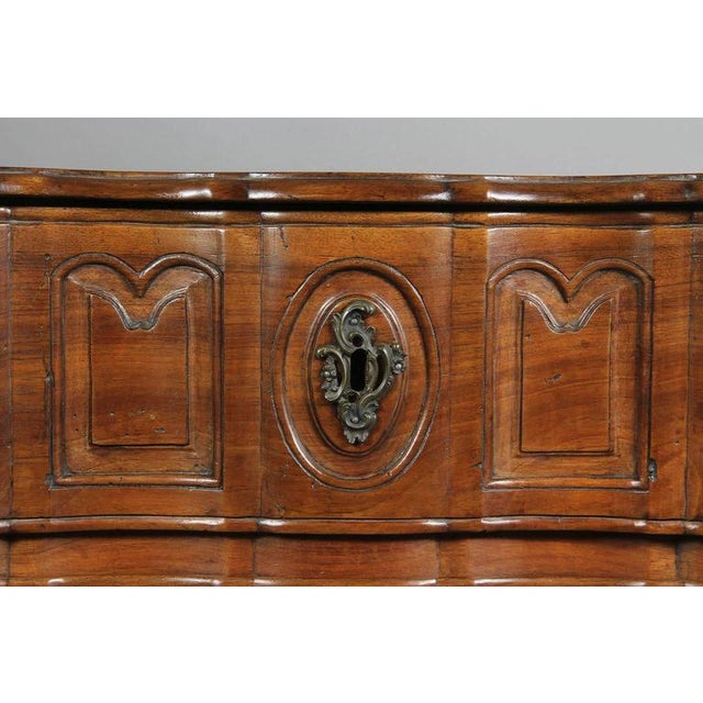 Shaped serpentine top over three conforming paneled drawers, shaped apron, ending on cabriole legs and hoof feet. In...