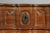 Shaped serpentine top over three conforming paneled drawers, shaped apron, ending on cabriole legs and hoof feet. In...