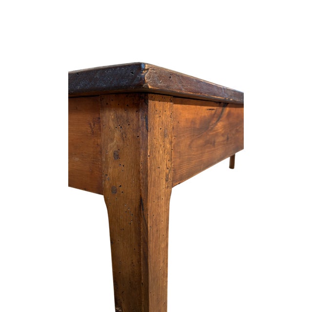 Solid rustic work table in fir wood dating back to the late 1800s. Characterized by simple and robust lines, it was...