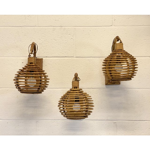 3 Wall lamps in wine and bamboo 70s. European Plug (up to 250V).The wiring of this item may be original and might need...