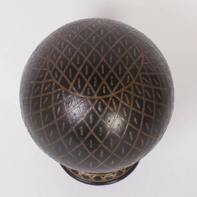 Unusual, vintage Anglo-Indian globe or orb crafted in ebonized wood and decorated in an elaborate well thought painted...