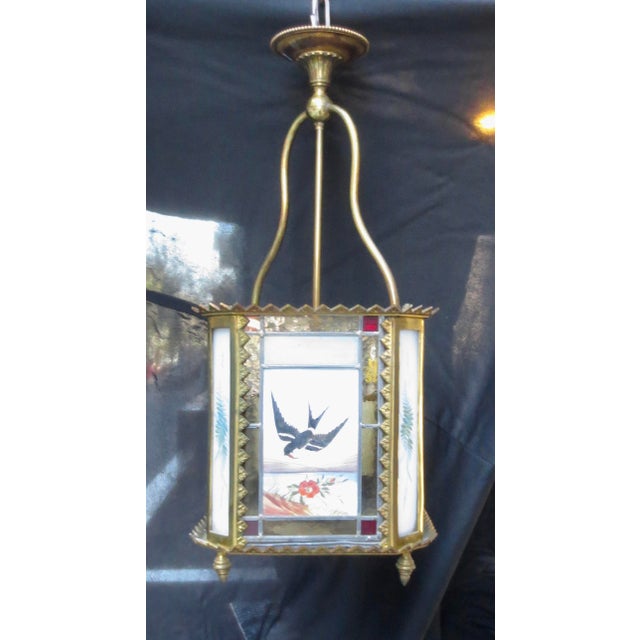 Leaded glass panels of painted bird scenes. Robin in the snow by the home, sparrows dart over fields over flowers, a color...