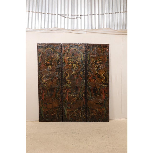 A fabulous pair of 7 ft. tall Italian leather embossed folding screens from the turn of the 17th and 18th century. This...