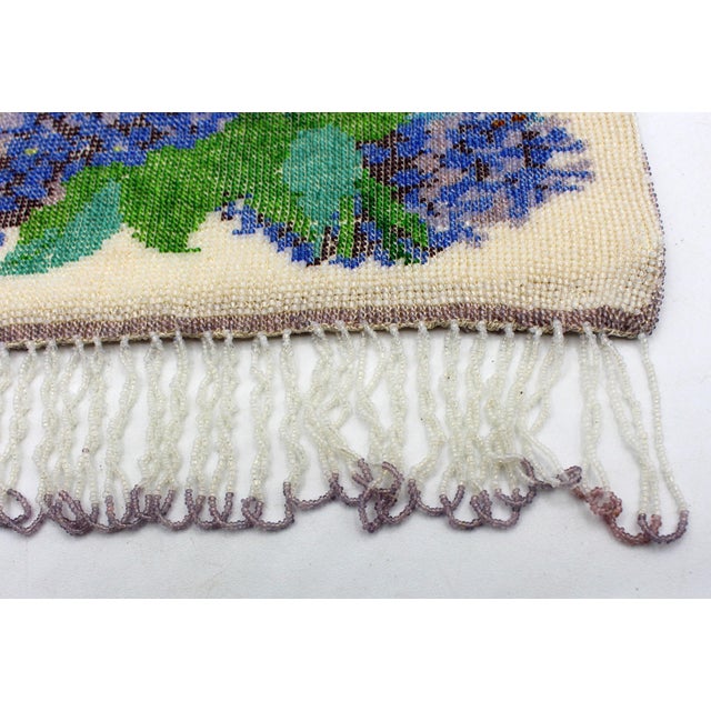 Micro-beaded floral tapestry purse, circa 1920s. The frame set with marcasites (2 lacking). Beading in fine condition....
