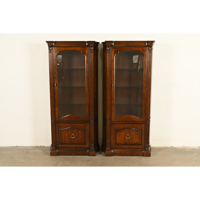 A gorgeous pair of French Regency Louis XVI style lighted bookcases, display cabinets, or dining cabinets By Davis Cabinet...