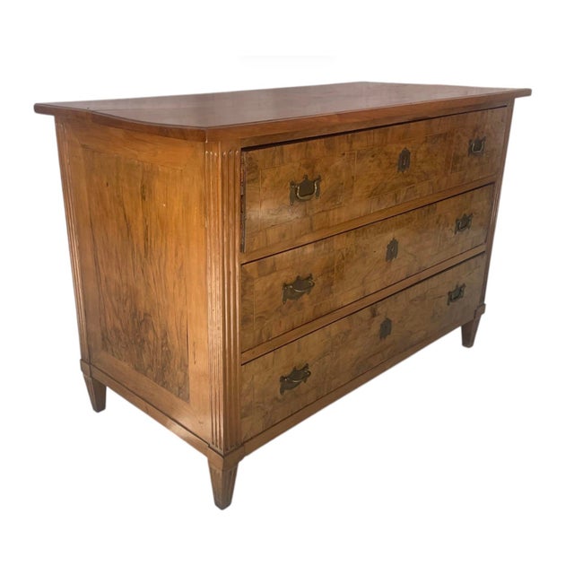 18th Century Italian Neoclassical Burl Wood Three Drawer Dresser. Dresser features a clean silhouette softened by...