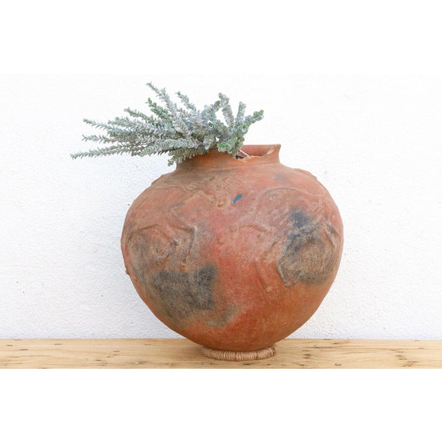 This monumental 20-inch tall terracotta vessel is a rare find from the West African Sahel region, likely of Malian or...