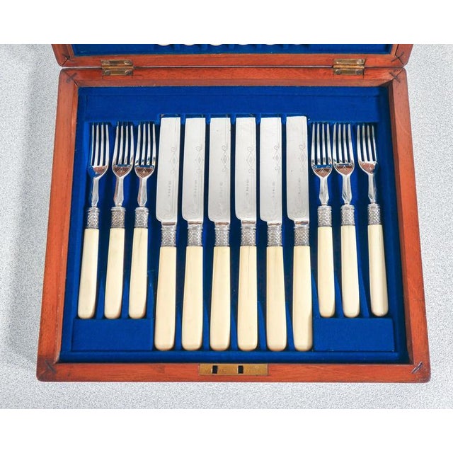 Set of 24 dessert cutlery william hutton, consisting of 12 knives and 12 forks. original wooden case origin england period...
