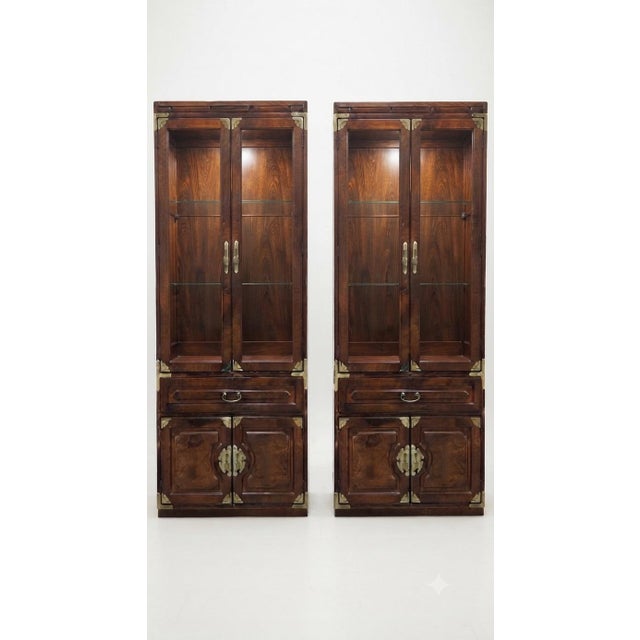 A wonderfully striking matching pair of vintage Asian-inspired display cabinets by Bernhardt, finished in a rich warm...