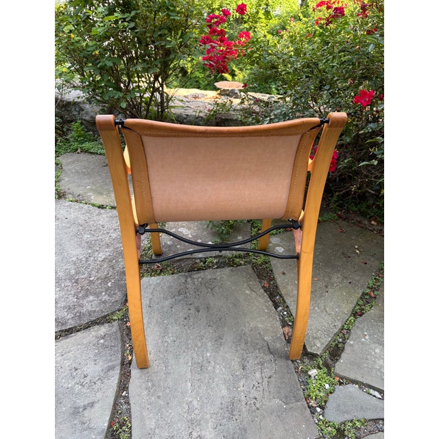 The chair is composed of a cold-drawn steel frame, a natural vegetable-tanned cowhide cover, and laminated beech and elm...