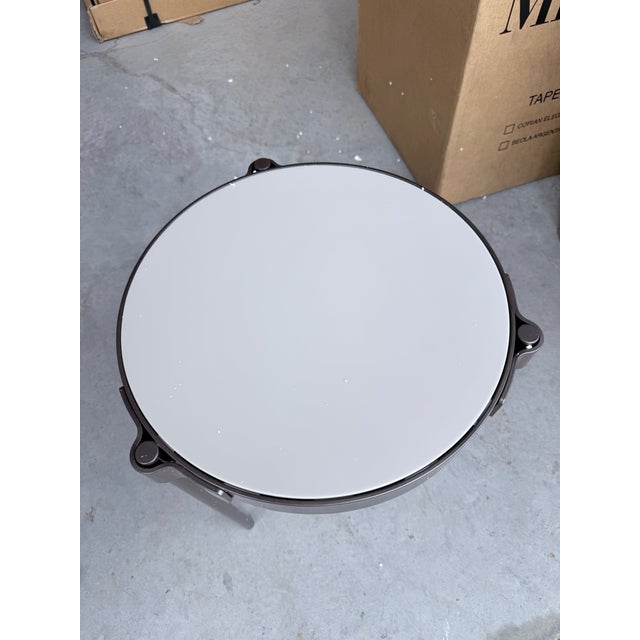 A refined architectural accent from the Minotti Tape Outdoor collection, this compact round side table features a sleek...