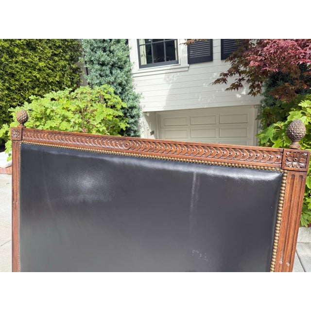 A beautifully detailed antique headboard in the Neoclassical Revival / Louis XVI style, featuring refined carving, elegant...