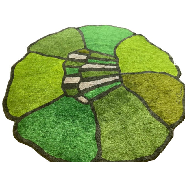 Vintage circular wool flower-shaped rug in various shades of green, designed by Wolf Bauer. Diameter 240 cm. Signed. This...
