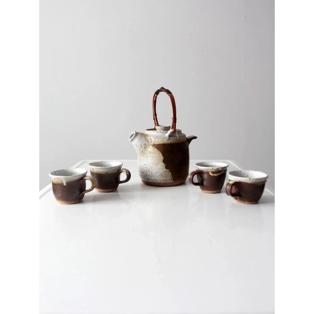 This is a vintage Japanese studio pottery tea service set including four hand-crafted mugs and a coordinating teapot....