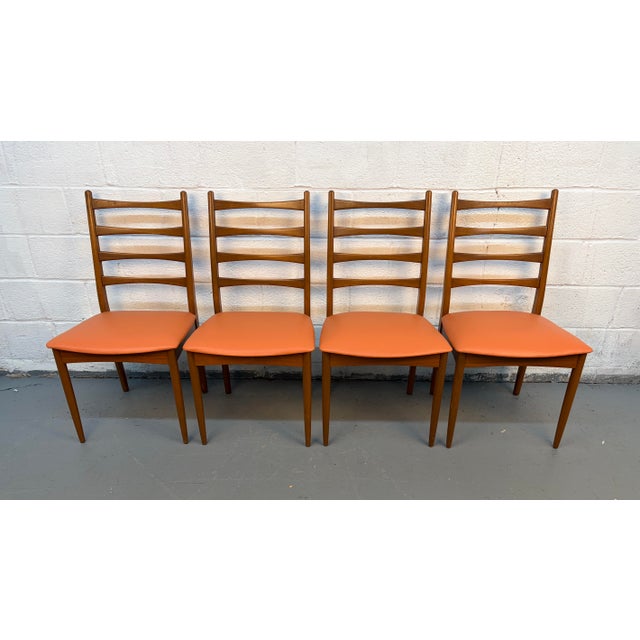 Bring refined mid-century style into your home with this striking set of four ladder back dining chairs by Greaves &...