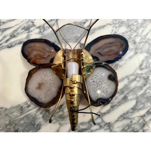 "Butterfly wall sconce with wings in sliced ​​agate, circa 1980, created by Hubert Deniau for Honoré Paris." In the 1980s,...