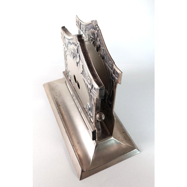 An exceptional late Victorian to early Edwardian silvered desk accessory, combining a functional perpetual calendar and an...