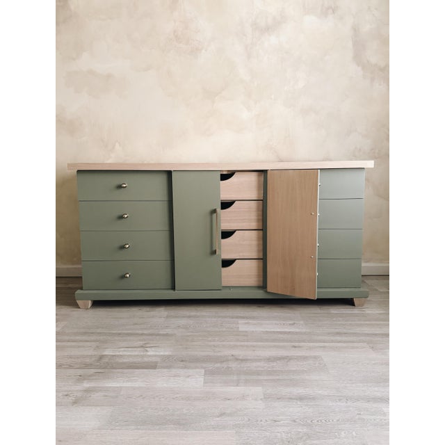 Soft sage green with a natural wood top—simple, warm, and easy to style. Clean lines, updated hardware, and great storage...