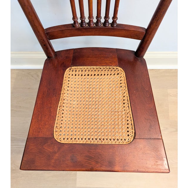 This is an antique (est. late 19th-early 20th century) mahogany chair with a lovely spindle back and hand woven cane seat....