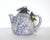 A vintage ceramic pottery lavender-blue cabbageware teapot with the body of trompe l'oeil cabbage leaves, and with blue,...