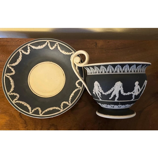 Large antique early 19th century black jasperware cabinet cup and saucer in the Wedgwood manner. Decorated with garlands...