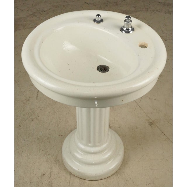 Vintage Art Deco porcelain ceramic pedestal sink on a fluted column base with overall streamlined geometry. This piece was...