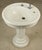 Vintage Art Deco porcelain ceramic pedestal sink on a fluted column base with overall streamlined geometry. This piece was...