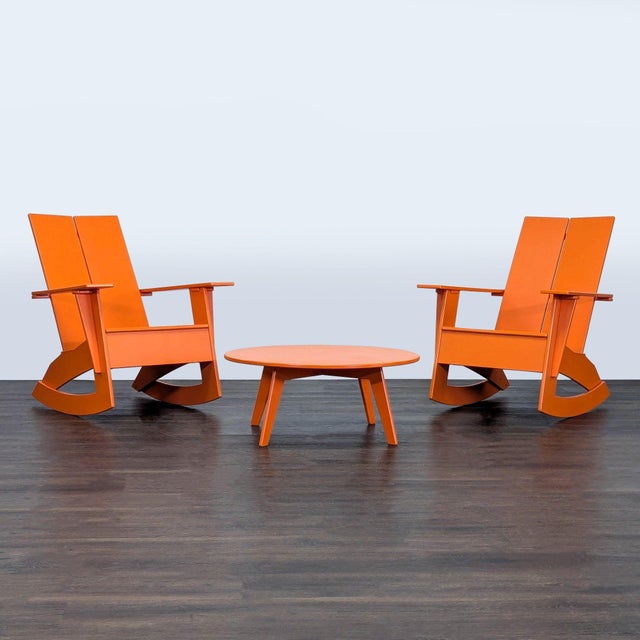 This Room & Board set includes two bright orange rocking chairs and a matching round coffee table. The modern design makes...