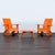 This Room & Board set includes two bright orange rocking chairs and a matching round coffee table. The modern design makes...