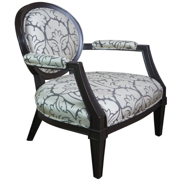 Two vintage Brunschwig & Fils armchairs featuring a wide stance with French fauteuil styling, oval balloon back and flared...