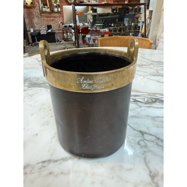 Vintage Italian champagne/wine ice buckets featuring elegant black cylindrical bodies with solid brass rims and integrated...