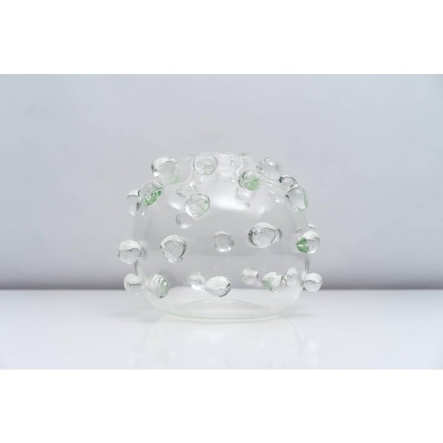 An exceptional vase designed by Luciano Gaspari for Salviati in 1962. The vase's clear glass body is covered with optical...