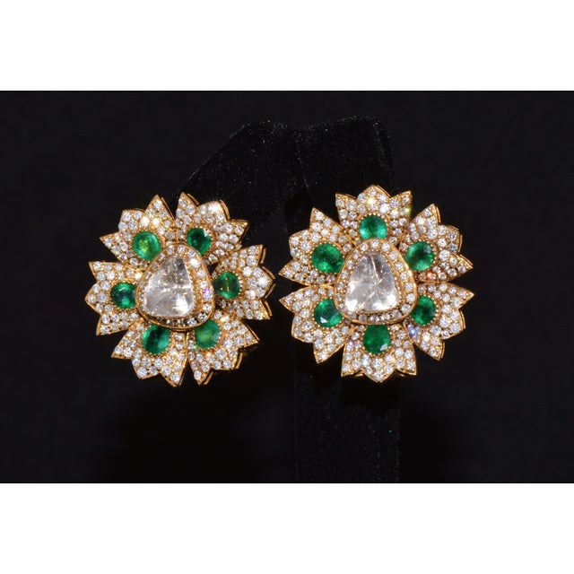 Authentic estate natural diamond and emerald floral earrings crafted in solid 18K yellow gold. These exceptional earrings...