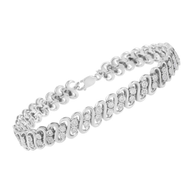 This striking link bracelet glistens with a double row of round cut diamonds set between S shaped links. Made in sterling...