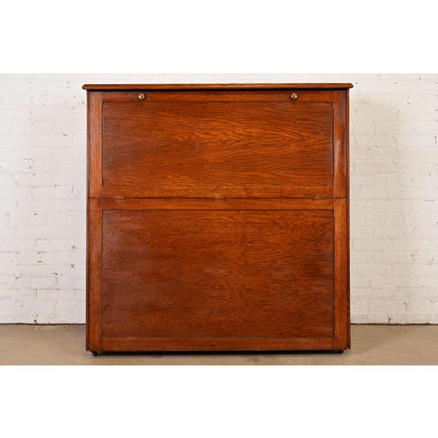 A beautiful and rare Mission or Arts & Crafts period oak slant front standing map case or cabinet In the manner of...