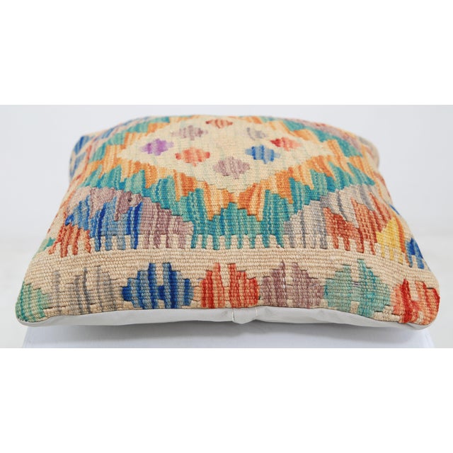 A one-of-a-kind handwoven Afghan wool kilim accent pillow featuring radiant diamond medallion in orange, teal and green....