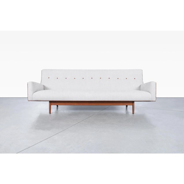 Mid-century modern walnut sofa designed by Jens Risom for Risom Designs, United States, circa 1950s. Model U-150 is a...