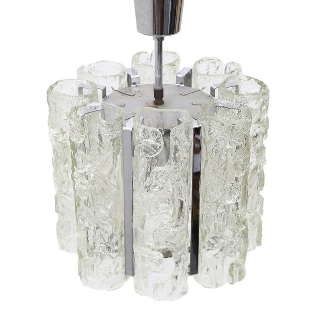 Italian manufacturing chandelier produced in the 70s. Rose window, stem and body chromed metal lamp. Glass speakers, hand...