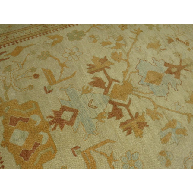 A 21st-century old wool Turkish oushak Room size rug Measures: 8'6'' x 10'2''.