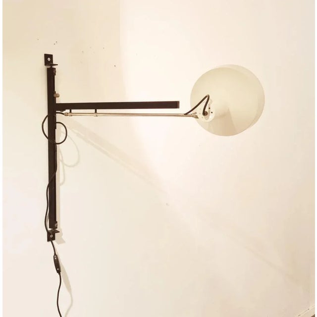 Very nice adjustable telescope wall lamp designed by Niek Hiemstra for Hiemstra Evolux, The Netherlands 1960. It has a...