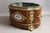 Wooden planter with a zinc interior. Beautiful gilt bronze ornamentation and a painted porcelain plaque on the front. Good...